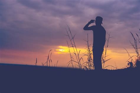 Premium Photo Silhouette Of Man Standing On Mountain At Sunset