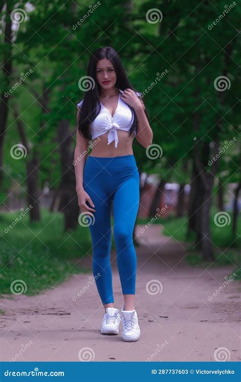 A Beautiful Slender Brunette Girl Athlete Coach Is Engaged On The Street Platform Stadium In