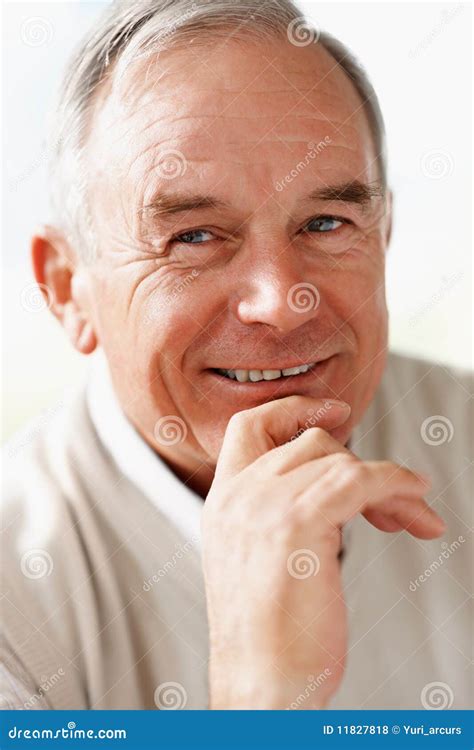 Closeup Of A Senior Man With Hand On Chin Smiling Stock Photo Image