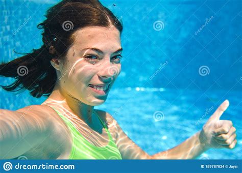 Child Swims Underwater In Swimming Pool Happy Active Teenager Girl