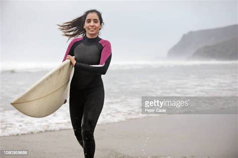 woman wetsuit running photos and premium high res pictures getty images