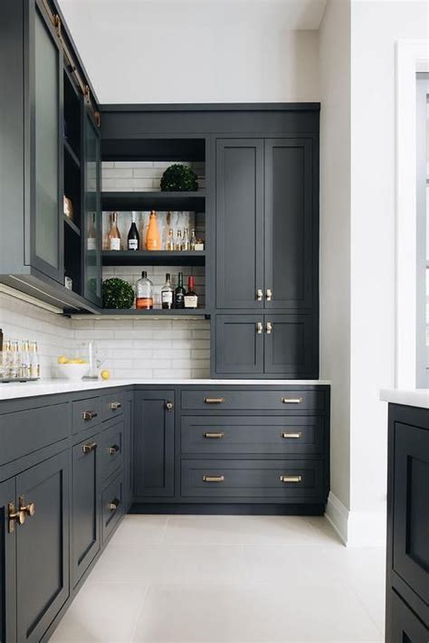 They also provide the perfect canvas for interesting hardware—dark brown, black or gray metal knobs, pulls and door handles provide a striking visual on. Black shaker kitchen cabinets adorned with vintage brass ...