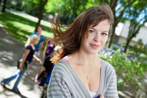 Portrait Of A Sweet College Girl With Friends In Background Photo And