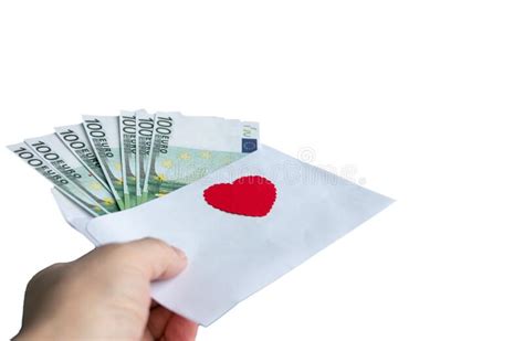 A Hand Holds A Paper Envelope With 100 Euro Banknotes And A Red Heart