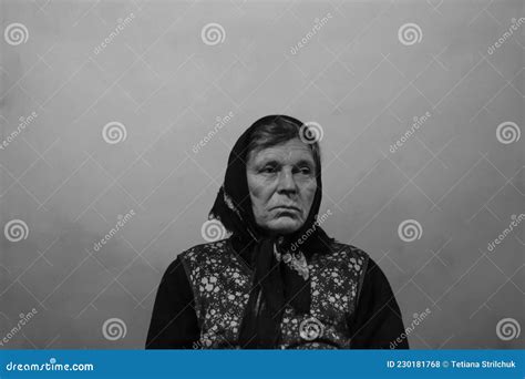 Defocus Portrait Of 60s Russian Grandmother Senior Old Woman Seating Indoors Old Women In Shawl