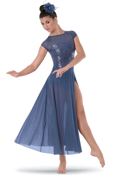 A Woman In A Blue Dress Is Dancing