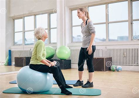 Physical Therapist Instructing A Senior Woman At Rehab Stock Image