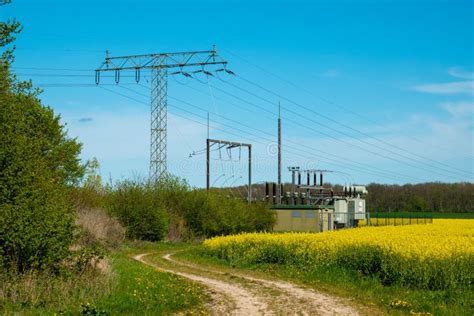 Electric Transformer Station Stands On A Canola Field Stock Image