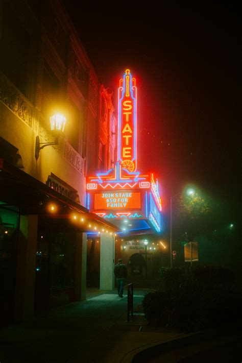 A Theater Sign Lit Up At Night On A City Street Photo Free Oroville