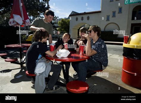 Group of teenagers eating at fast food stand Stock Photo - Alamy