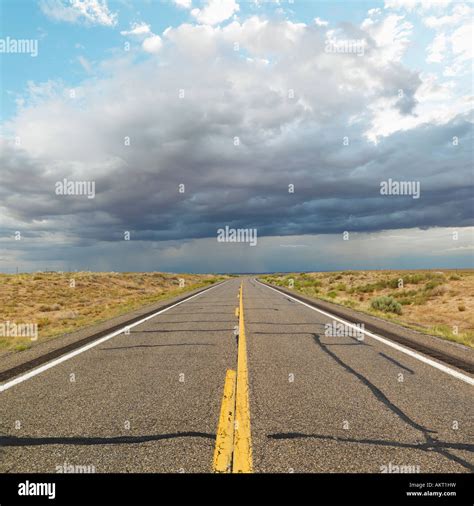Empty Two Lane Highway Leading To Desert Horizon Stock Photo 15065892