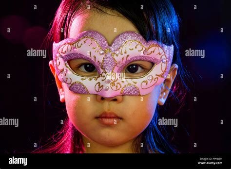 Asian Little Chinese Girl Wearing Mask Isolated On Black Bakground