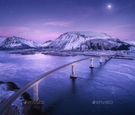 Aerial View Of Bridge Snow Covered Mountains Purple Sky Aerial View