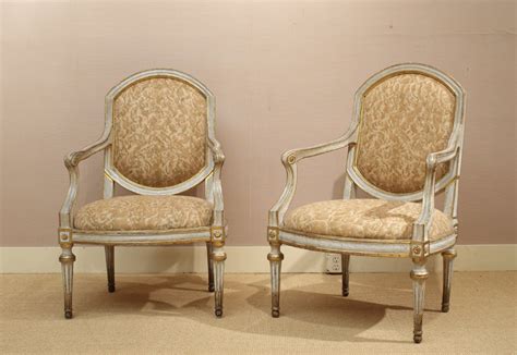 A Set Of Four Large Italian Neoclassic Grey Painted And Giltwood