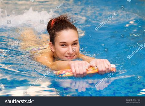 Girl Learn To Swim With Board In The Swimming Pool Stock Photo 32404180
