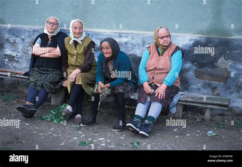 Four Old Ladies On A Seat At The Roadside In Danesti Csikdanfalva