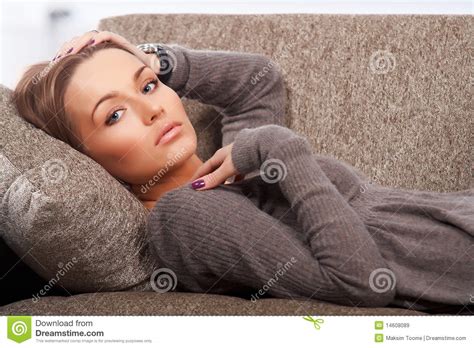 This is in the present tense, where you are talking about doing something. Lying on the couch stock image. Image of couch, golden ...