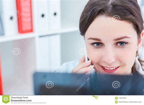 Maybe you would like to learn more about one of these? Female Doctor Using Phone While Studying Xray At Desk In ...