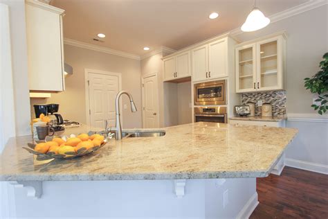 Kitchen With Light Granite Counter Tops Wood Floors And White