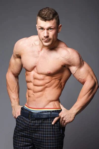 Muscular Athlete Bodybuilder Man On A Gray Background Stock Photo Bondarchik