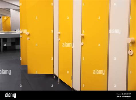 Public Toilet Interior With Bright Yellow Stalls Stock Photo Alamy