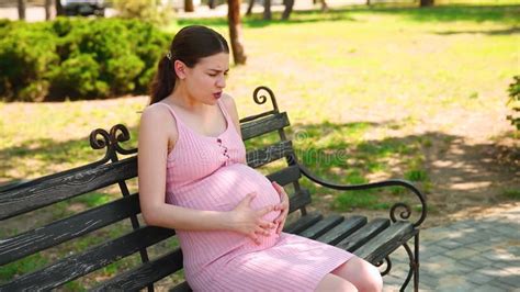 A Pregnant Girl Is Standing In The Park And Her Stomach Begins To Hurt A Pregnant Woman