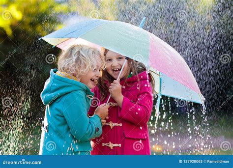 Kids With Umbrella Playing In Autumn Shower Rain Stock Image Image Of