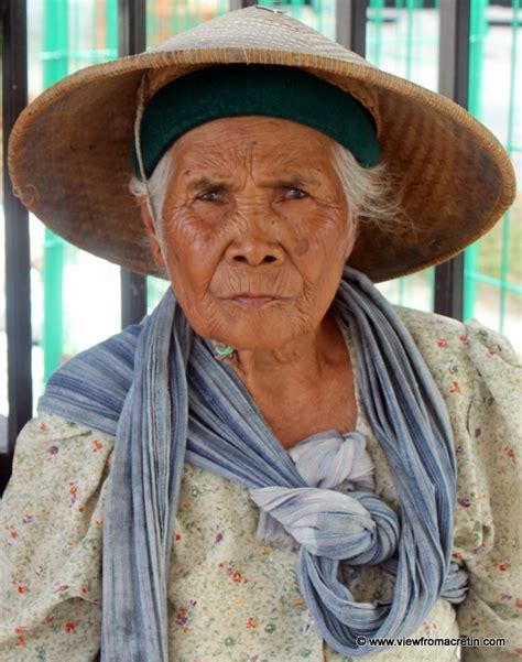 An Old Indonesian Woman Shes Wearing A Traditional Cap Named Caping It Protects Her From The
