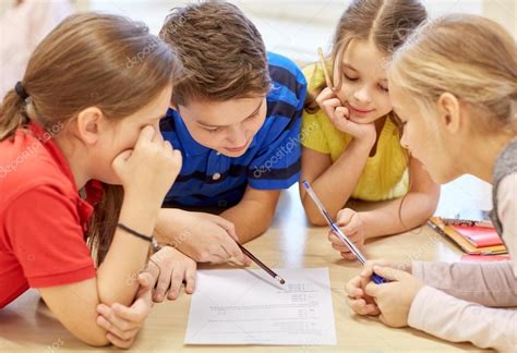 Group Of Students Talking And Writing At School Stock Photo By ©syda