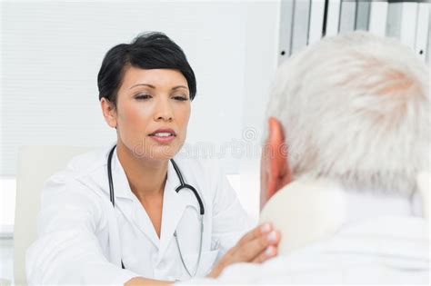 Female Doctor Examining A Senior Patients Neck Stock Photo Image Of