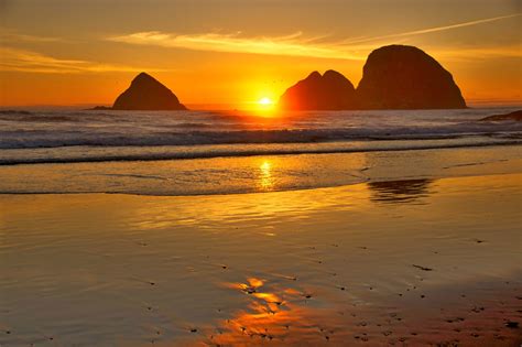 Sunset At Three Arch Rocks Along The Oregon Coast In The Pacific