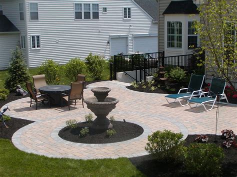 Curved Patio With Water Feature Fountain Using Pavers And Soldier