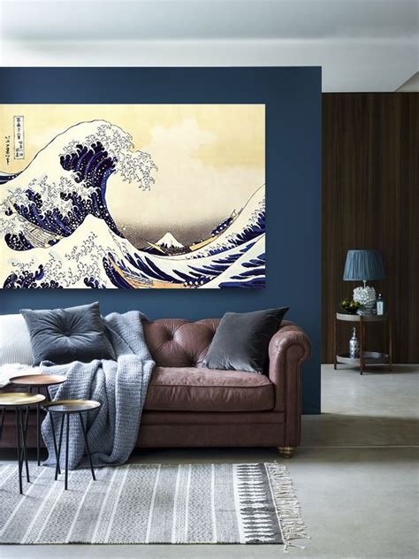 a living room filled with furniture and a large painting on the wall