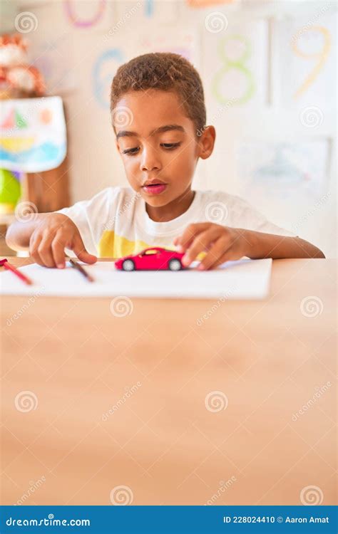 Beautiful African American Toddler Sitting Drawing Using Paper And