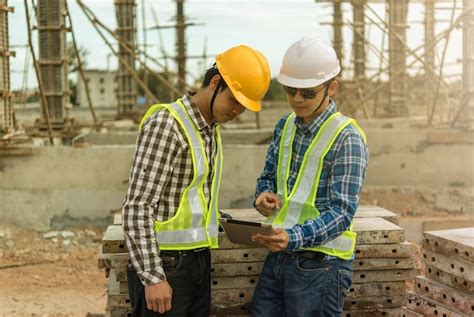 Premium Photo Two Young Man Architect On A Building Construction Site