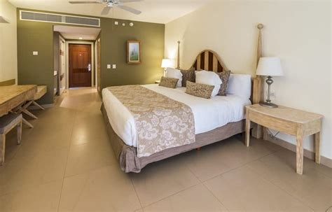 This glamorous primary bedroom features green and white walls along with tiles flooring and a couple of table lamps. 50 Primary Bedrooms with Tile Flooring (Photos) - Home Stratosphere