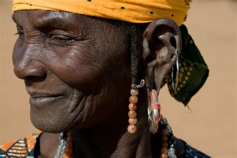 A Fulani Woman With Big Earring And Yellow Head Cover In Fine Art