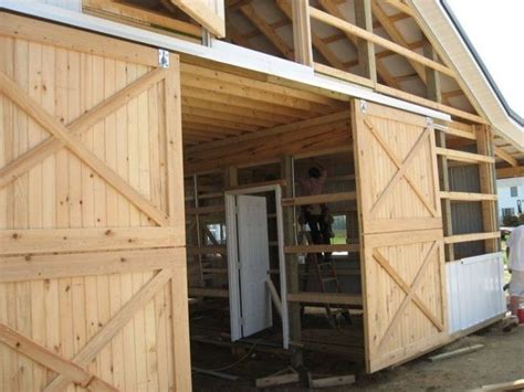 Because the barn door is made mostly of solid wood or metal. large and rustic sliding barn door design with double ...
