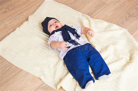 Portrait Of A Little Adorable Newborn Infant Baby Boy Lying On Back On