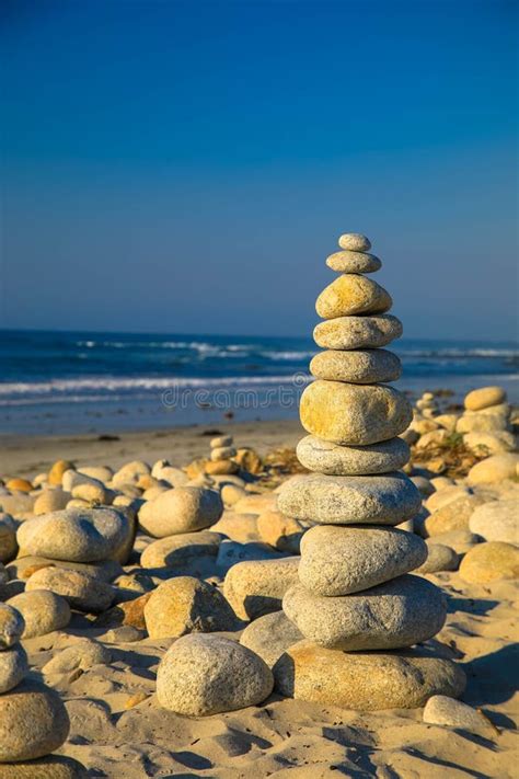 Stack Of Zen Stones On Pebble Beach Beach Landscape Stock Photo