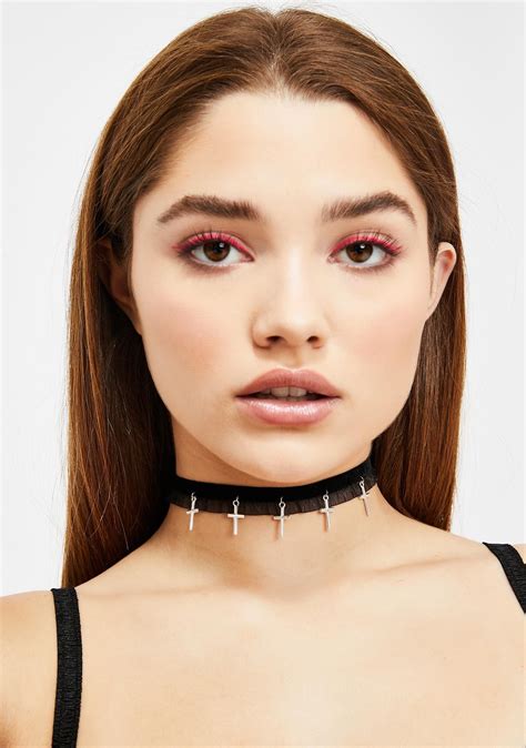 A Woman Wearing A Choker With Crosses On The Front And Neck In Black