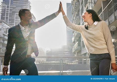 We Did It Two Young Businesspeople High Fiving While Standing On An