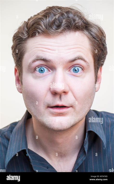 Portrait Of Young Surprised Shocked Emotional Big Eyes Man With Open