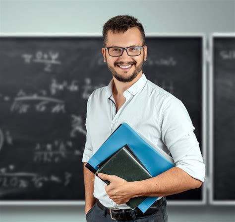 Portrait Of A Young Male Teacher On The Background Of The School