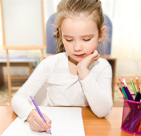 Little Girl Is Writing At The Desk In Preschool Stock Image Image Of