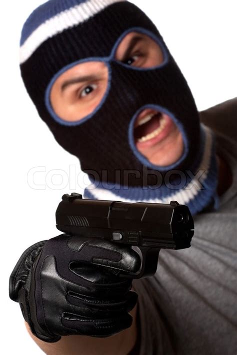An Angry Looking Man Wearing A Ski Mask Pointing A Black