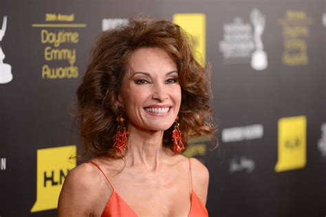 check out susan lucci s age defying beauty at 74 as she lies on her bed wrapped in a towel