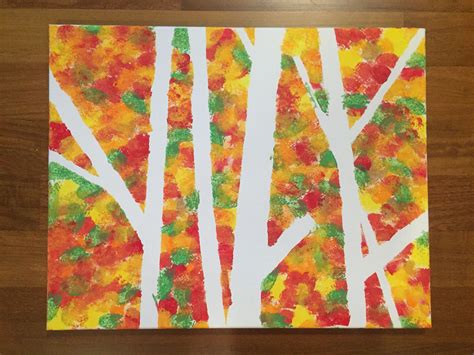 an art project made with tissue paper and colored leaves