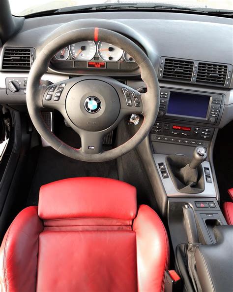 The Interior Of A Car With Red Leather Seats And Steering Wheel