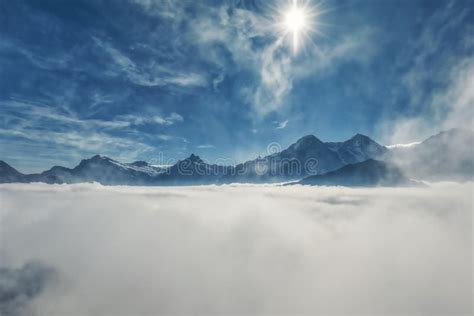 Beautiful Panorama Of Swiss Alps Mountains In The Fog Stock Image
